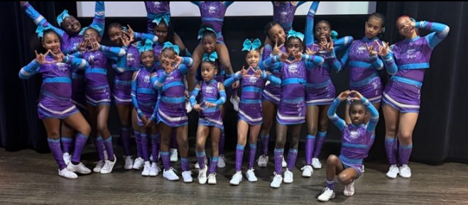The Diamond Eagles team lined up in purple and teal uniforms making diamond hand signs
