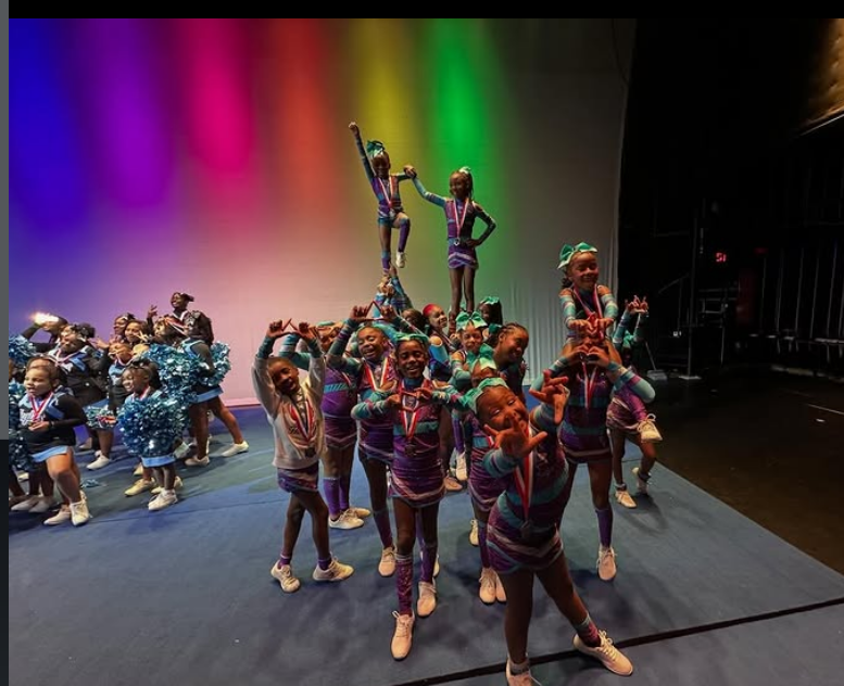 Diamond Eagles athletes holding a pyramid formation under the competition lights
